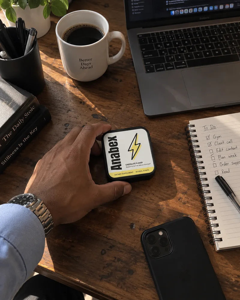 Man at his desk with an Anabex tin next to his laptop