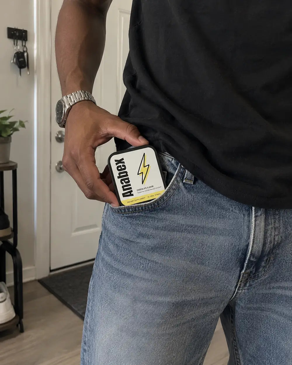 Black Anabex tin sliding into a jeans pocket